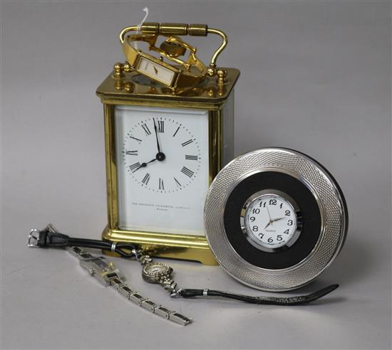 A brass carriage timepiece, a Christofle quartz timepiece and three wrist watches.